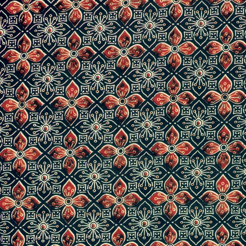 Patterned fabric with red and blue design on a dark background
