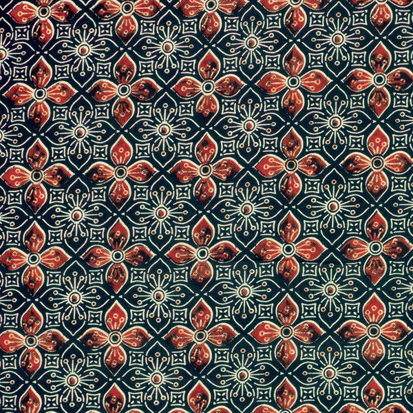Patterned fabric with red and blue design on a dark background