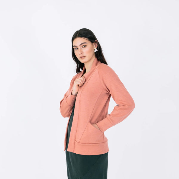 Woman wearing a pink jacket on a white background
