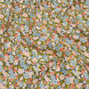 Floral fabric pattern with small flowers in pink, blue, and green on a dark background