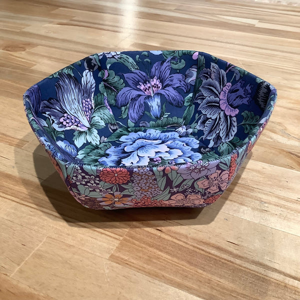 Decorative bowl with floral pattern on a wooden surface