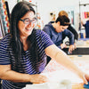 Woman working with fabric in a workshop setting