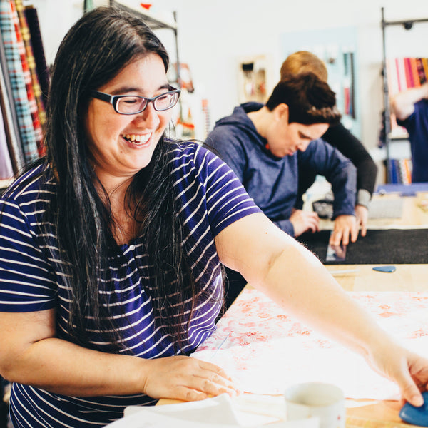 Woman working with fabric in a workshop setting