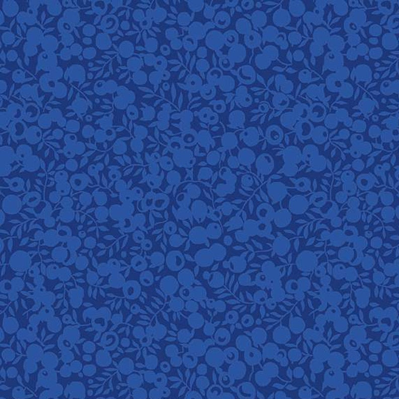 Blue fabric with a subtle pattern on a blue background