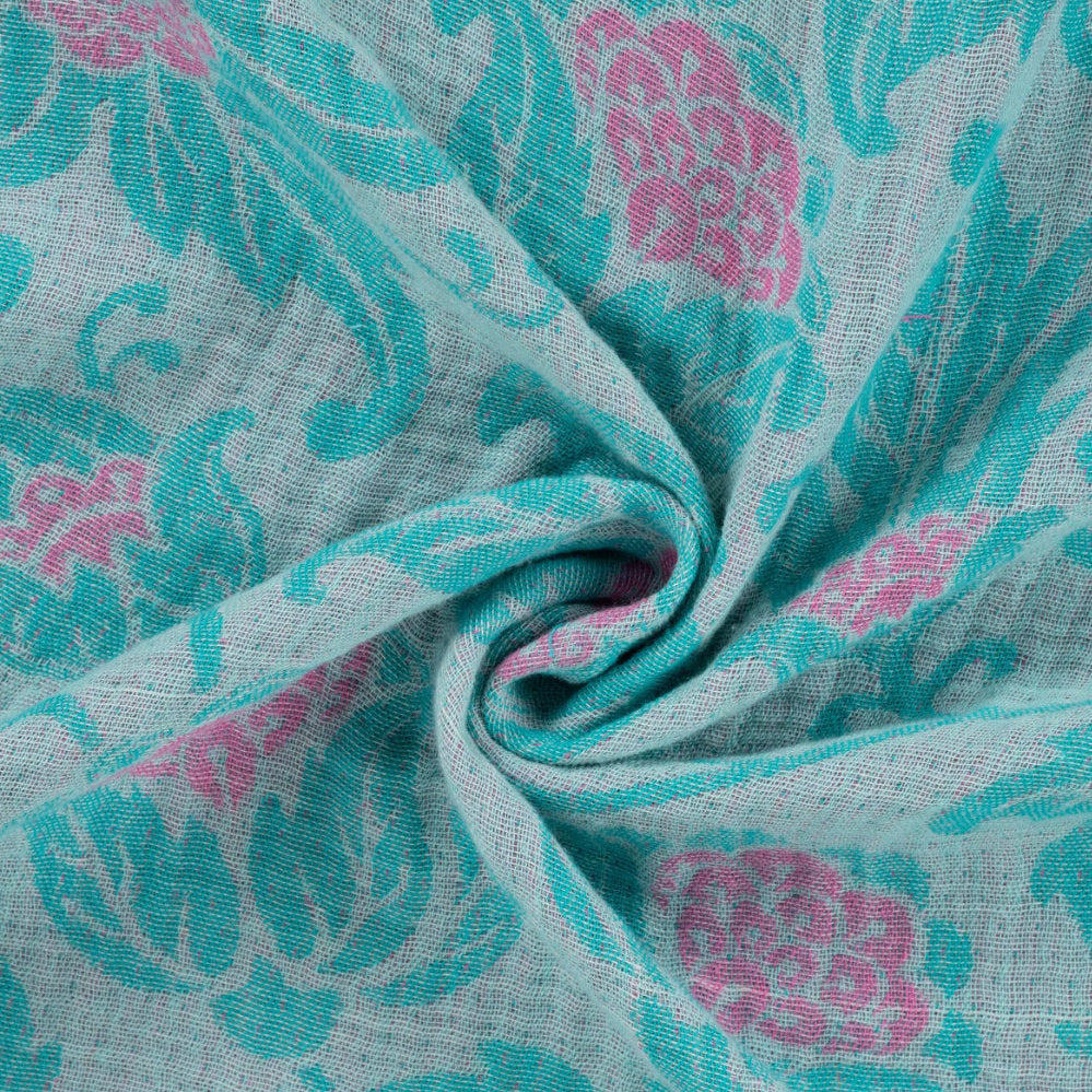 Close-up of fabric with pink and teal floral pattern